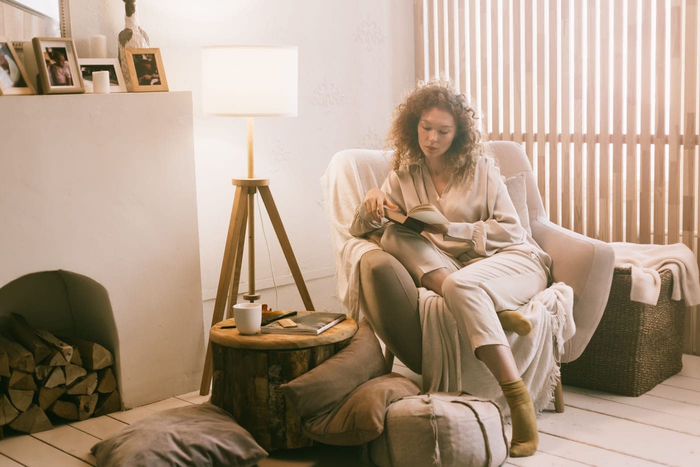 An armchair beside a reading lamp in an evening room