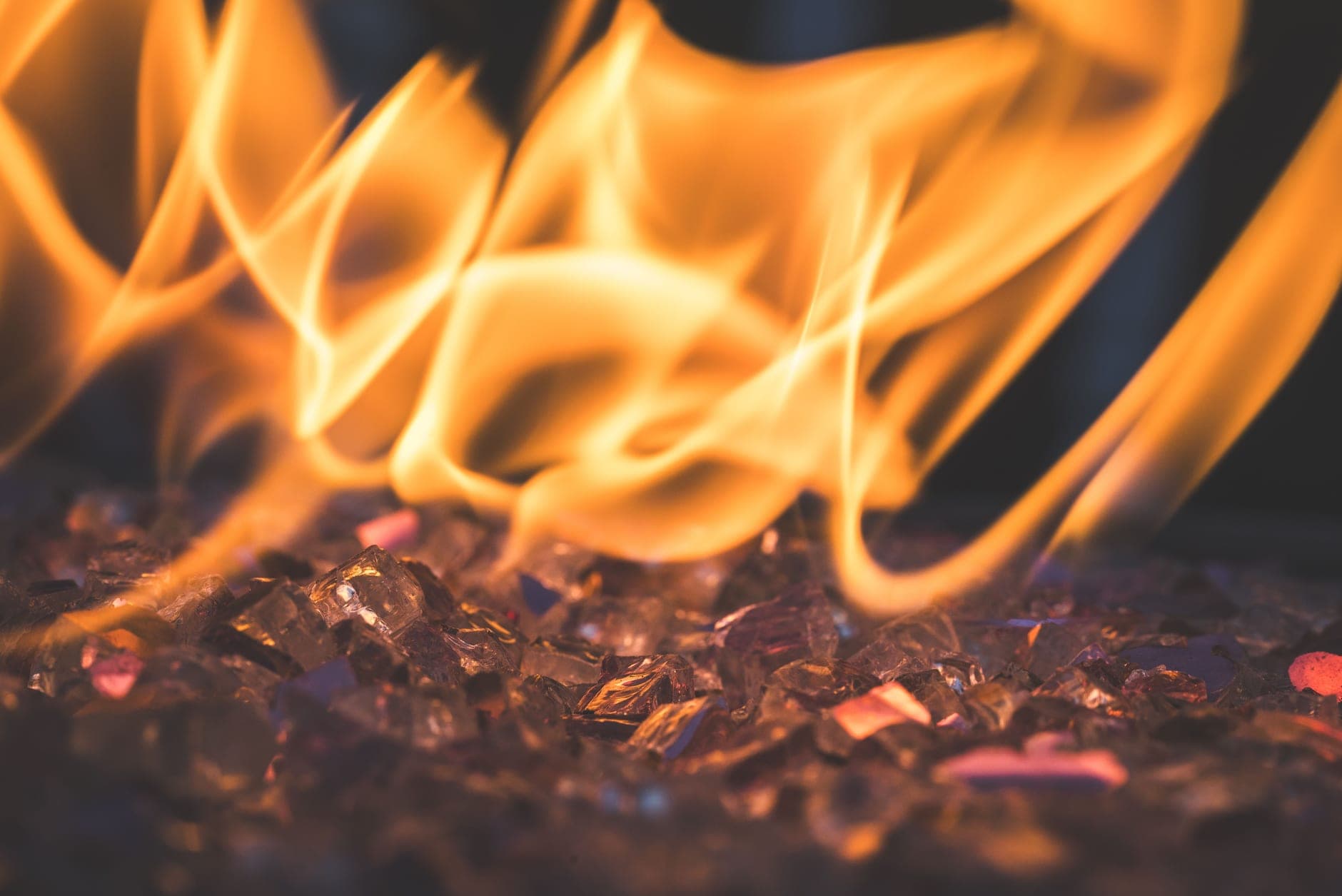 A line of real flame burning over decorative glass media