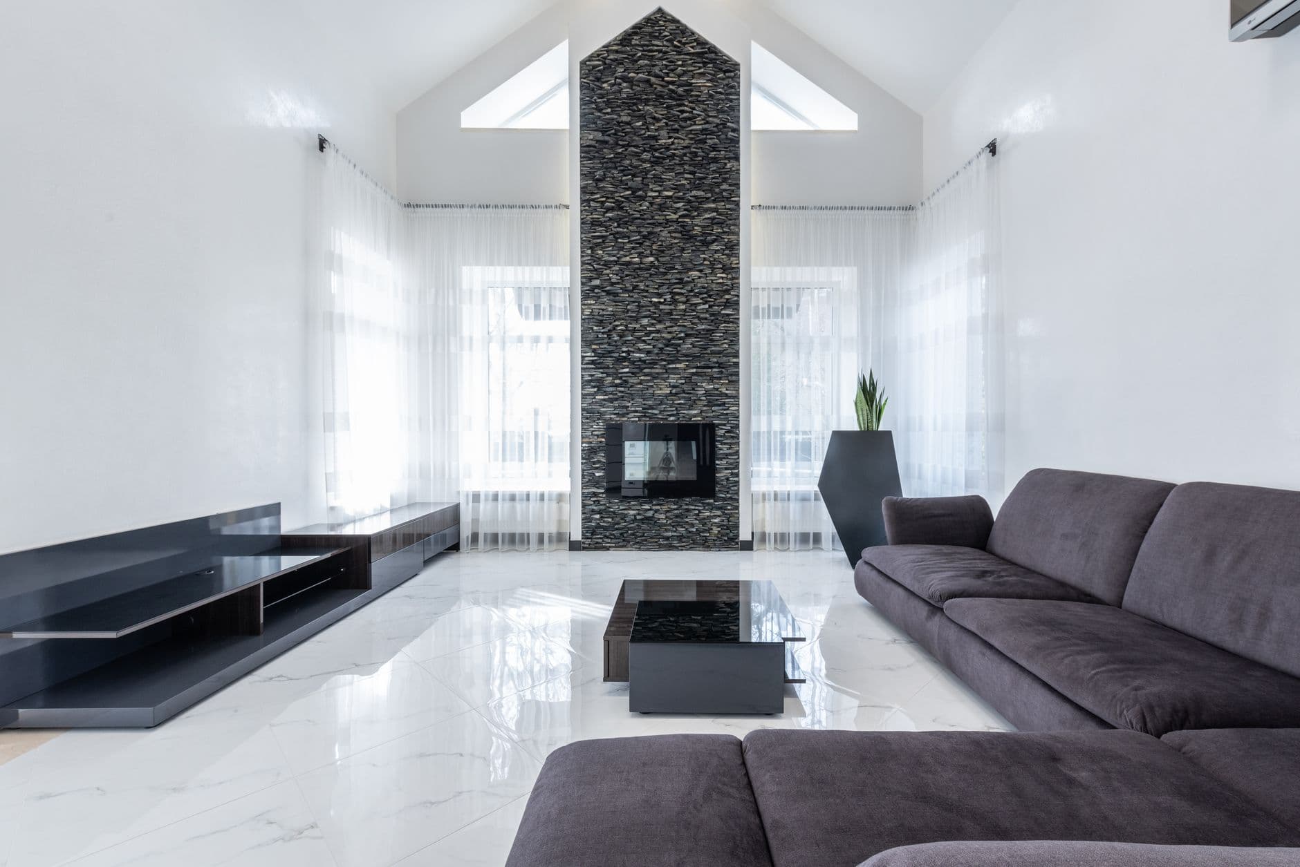 A spacious living room with a linear electric fireplace