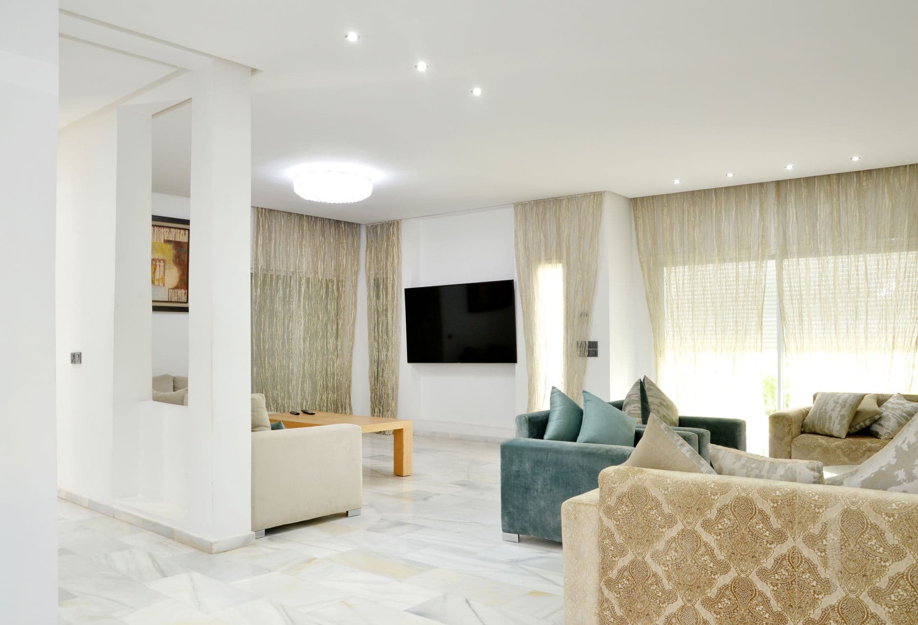 A spacious modern living room with elegant sofas and considered decor