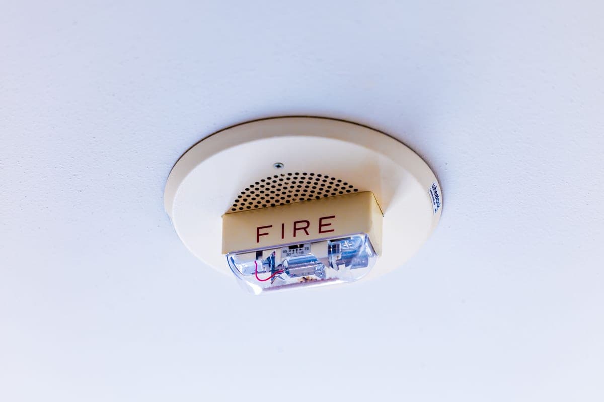 A smoke detector mounted on a ceiling
