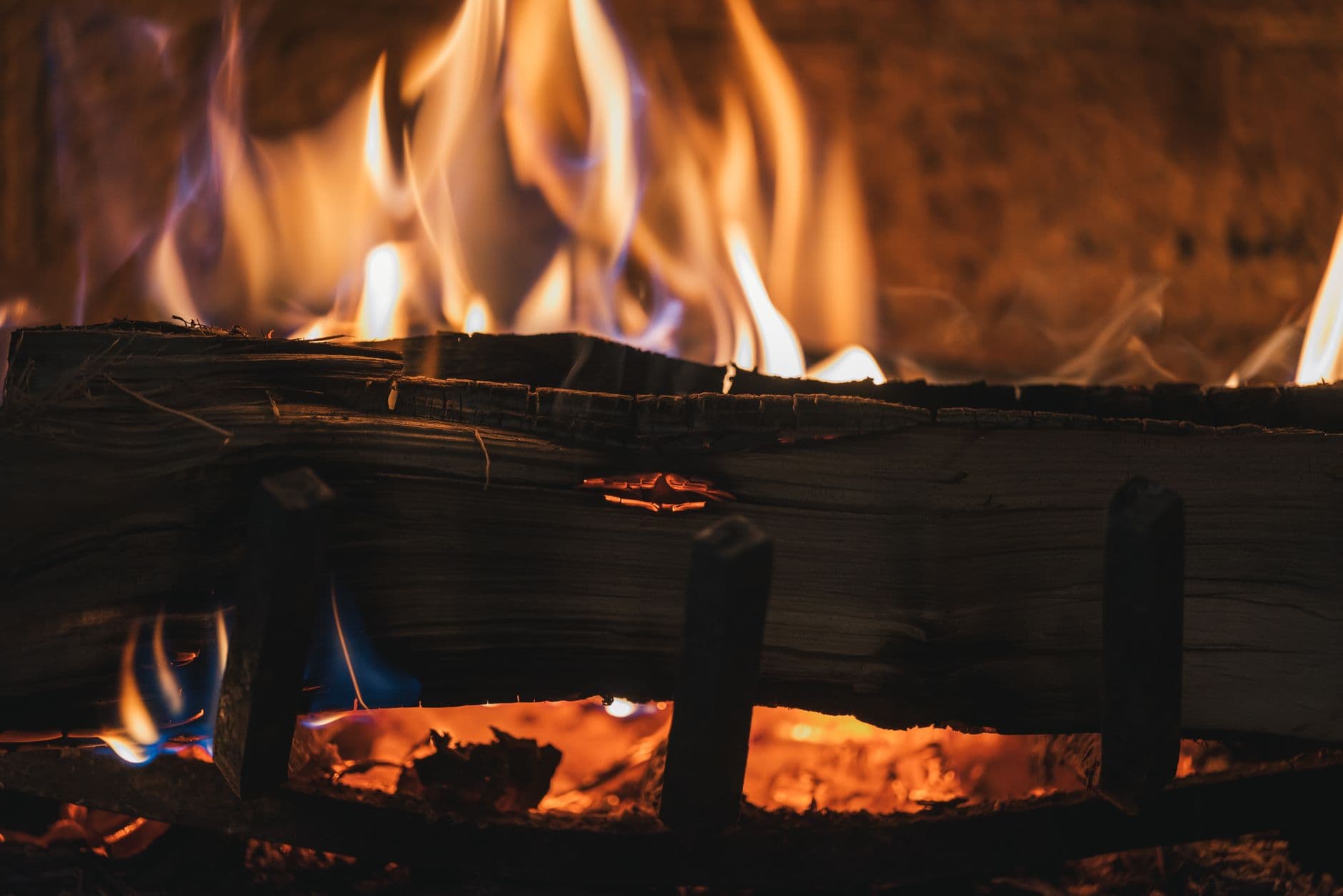 A close-up of a fireplace with burning logs and vivid flames