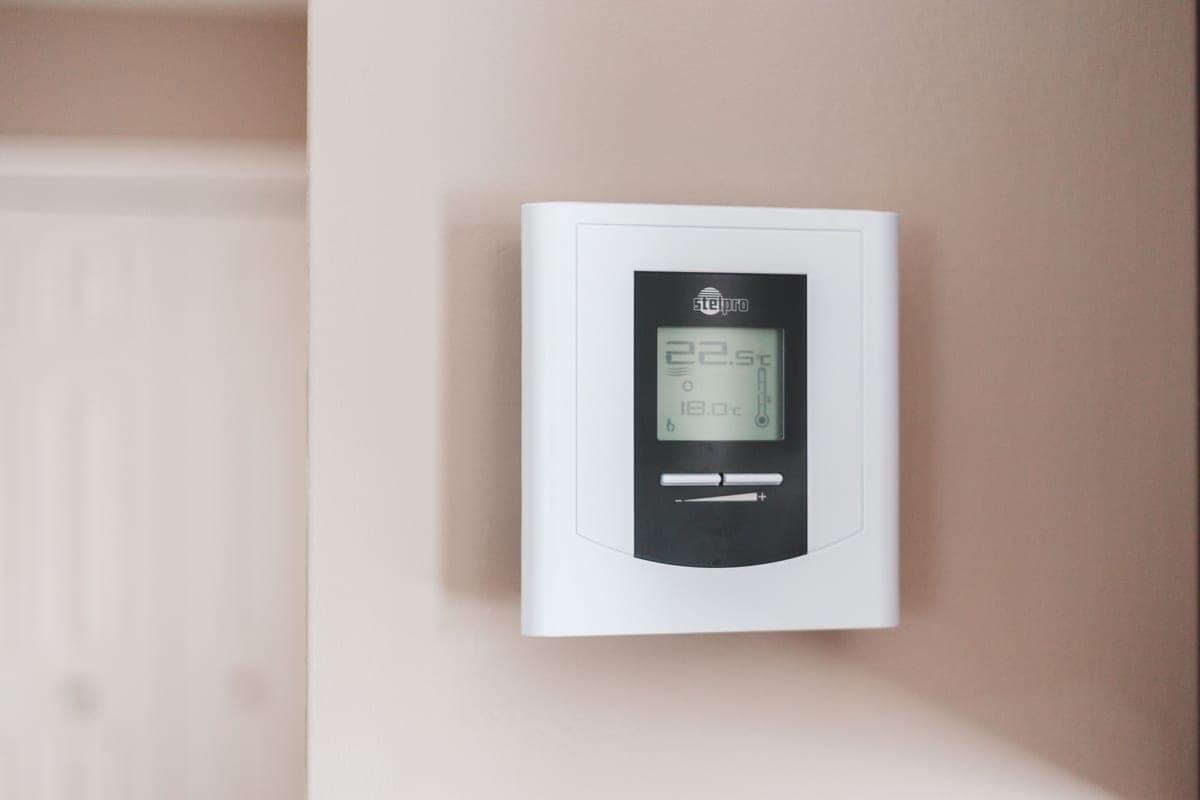 A wall thermostat in a home hallway