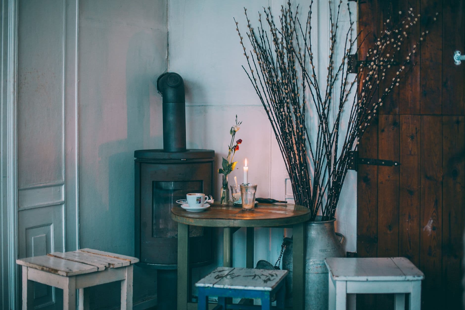 A country interior with an iron stove beside a table