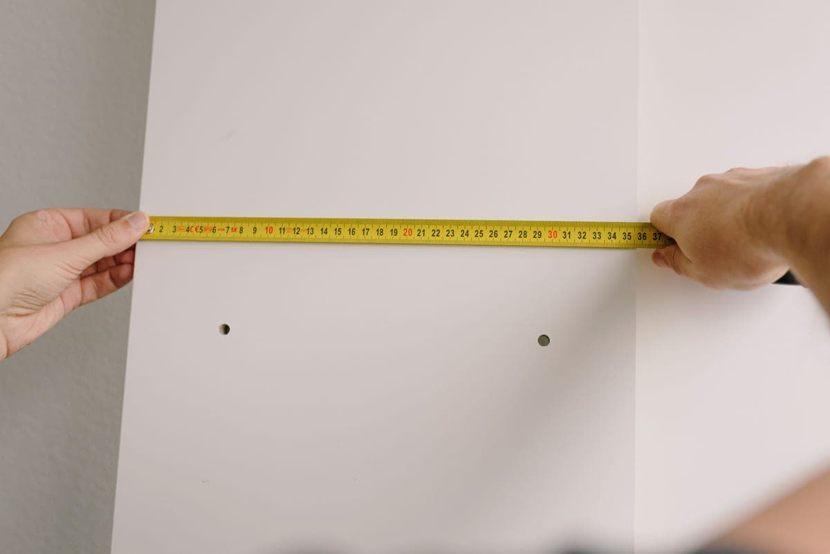 A tape measure held against a wall