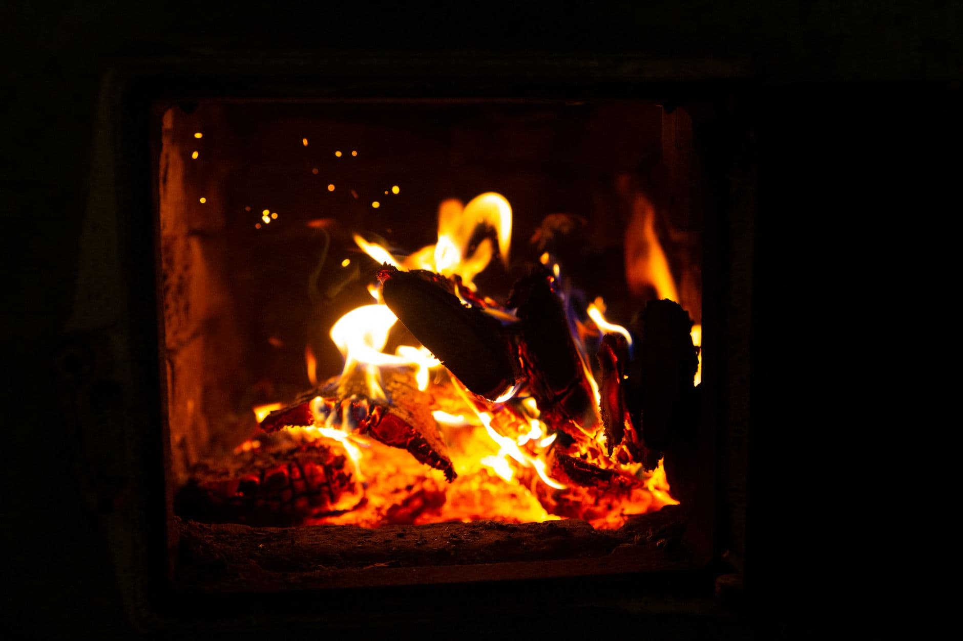 A close-up of burning logs inside a fireplace