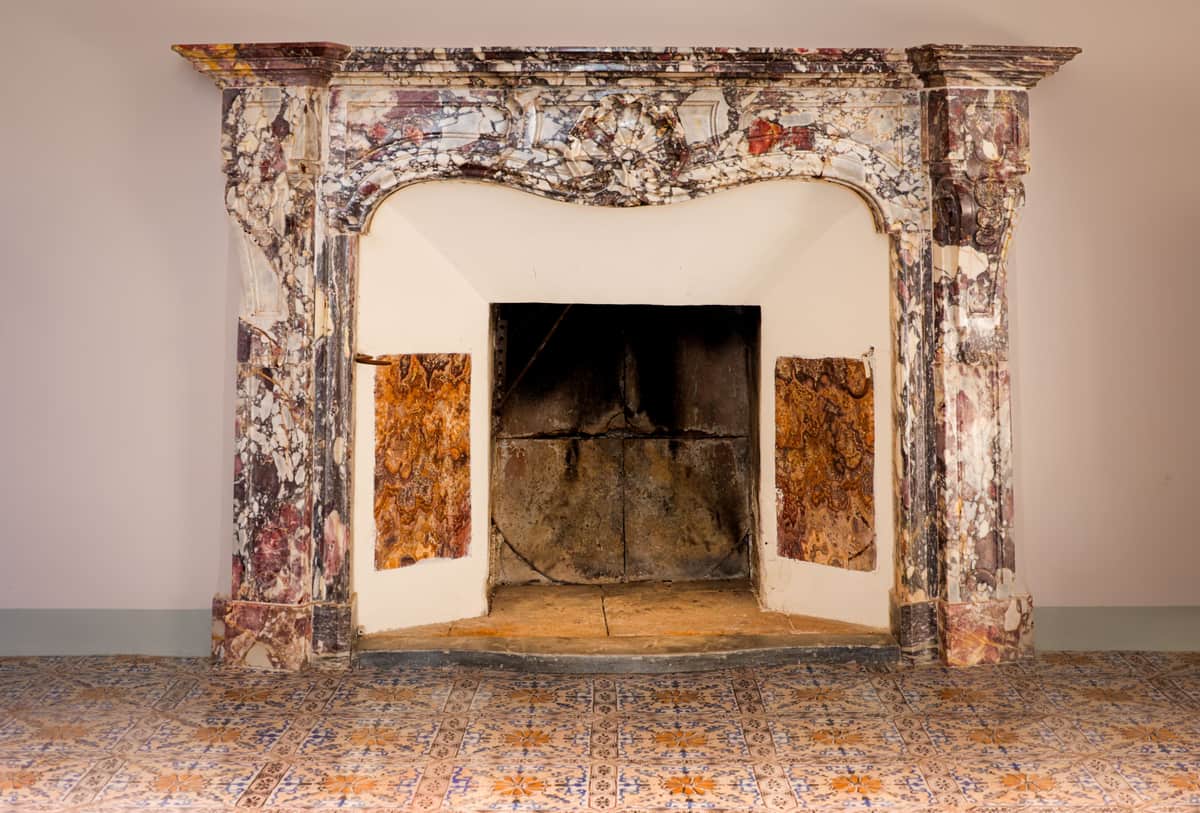 An empty stone hearth in a lived-in room