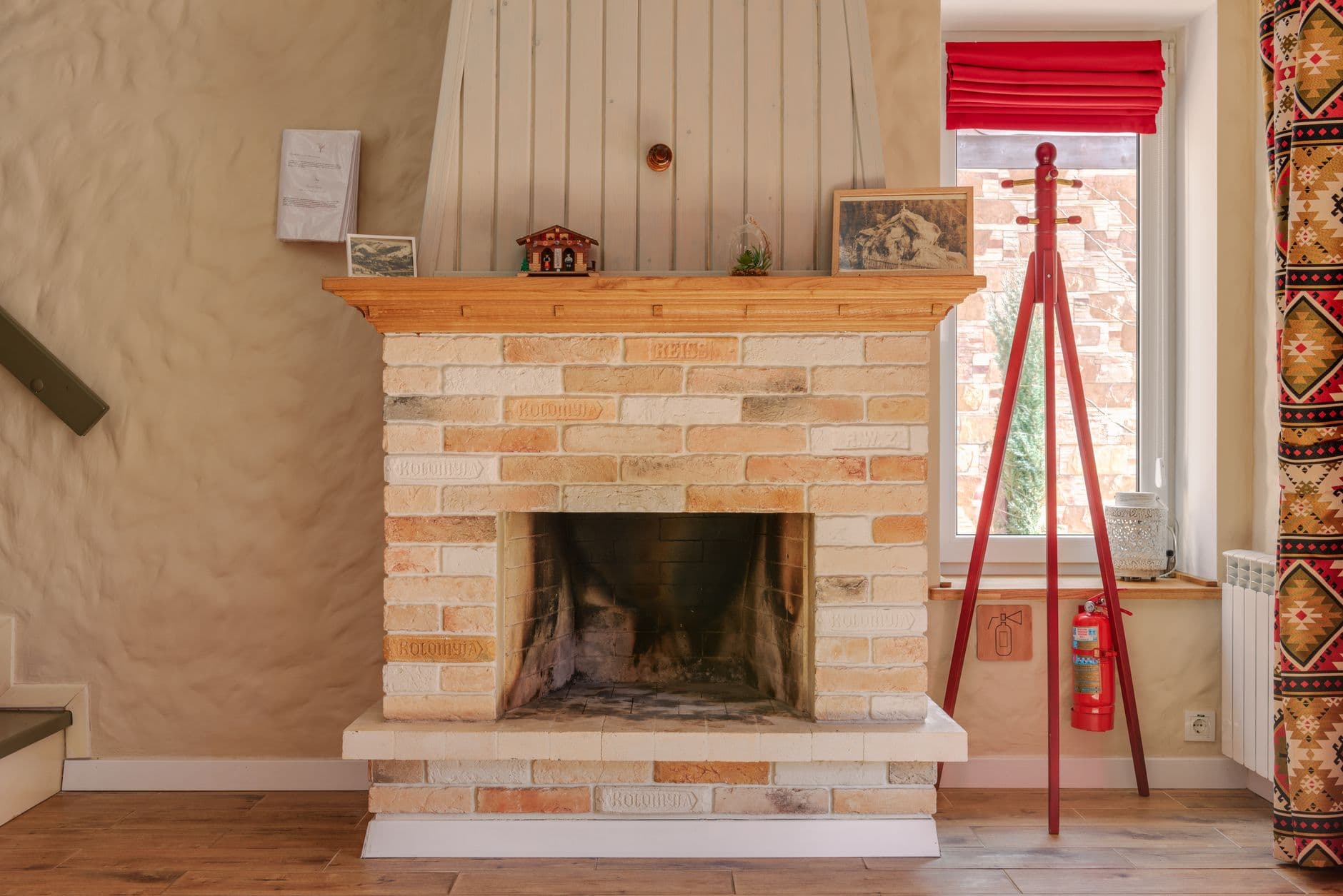 A living room with a rustic brick fireplace
