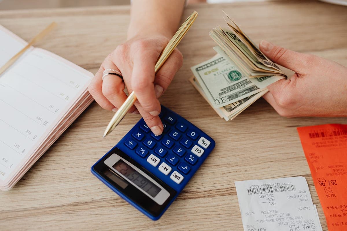 A household budget and calculator on a kitchen table