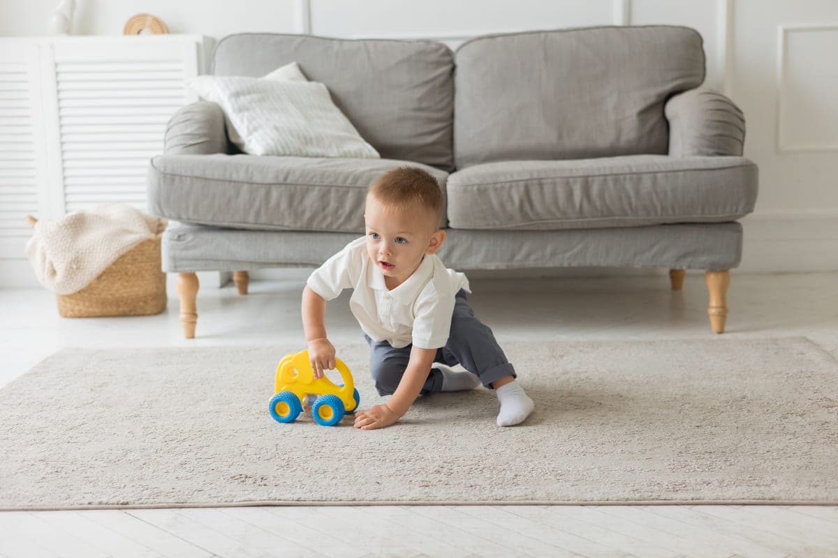 A child playing on a living room floor