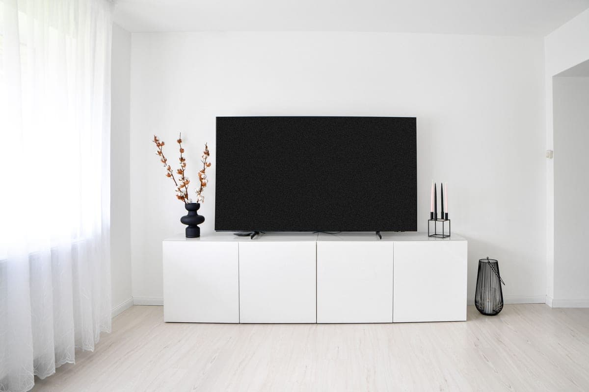 A media console below a television in a living room