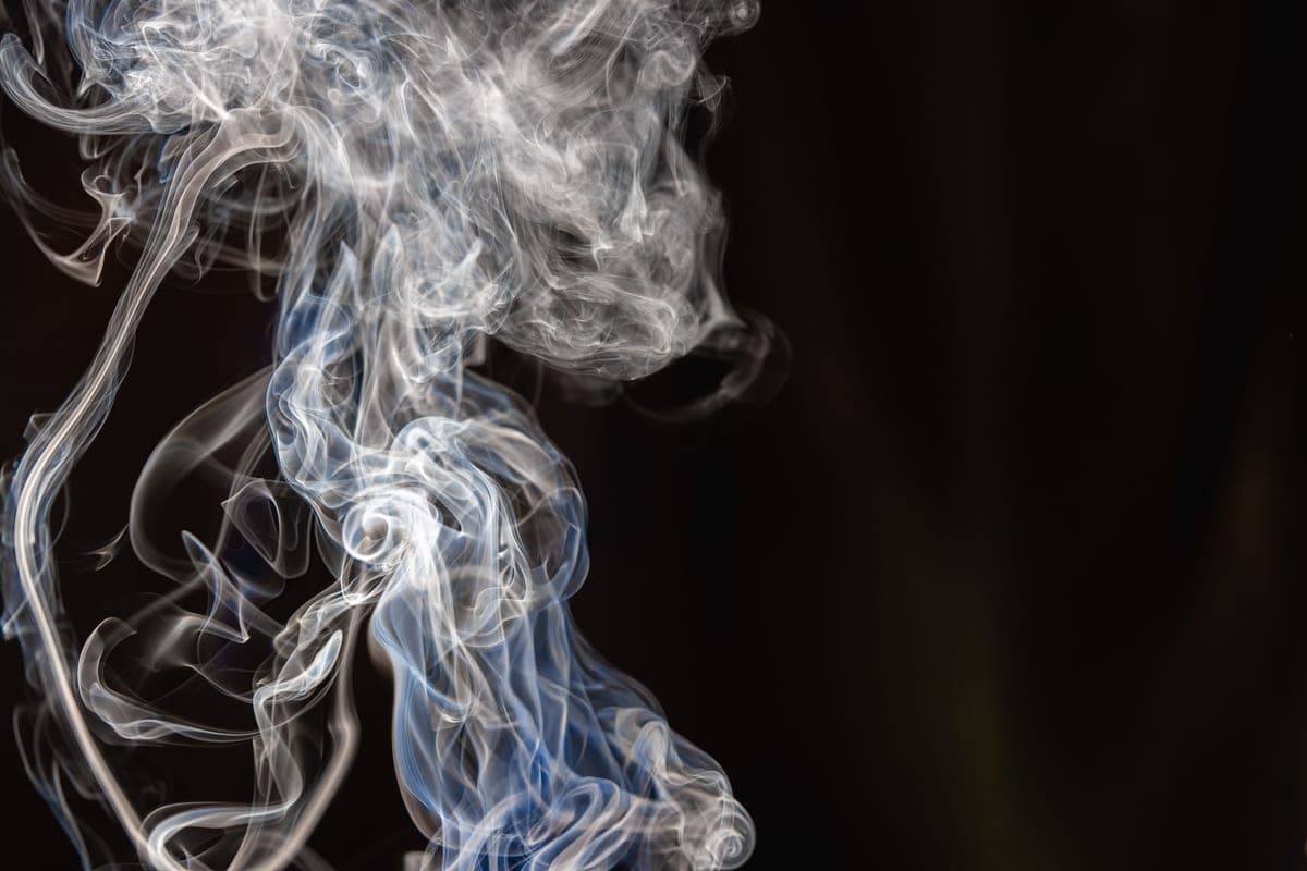 A wisp of smoke against a dark background