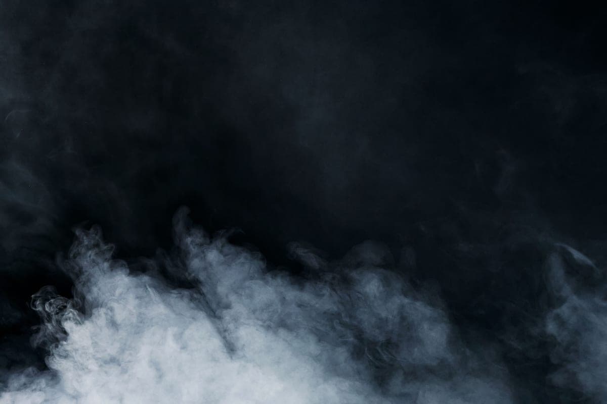 Mist and steam rising against a dark background