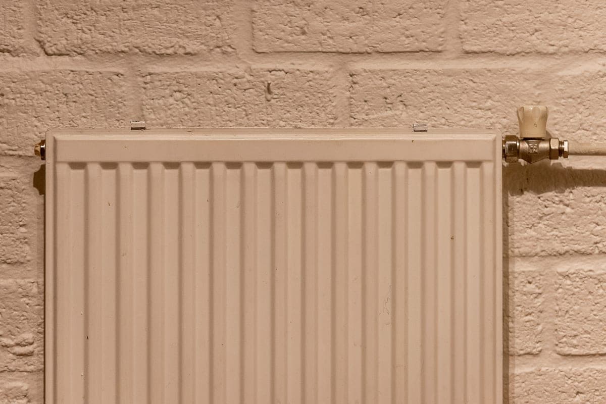 A radiator beneath a window on a cold day