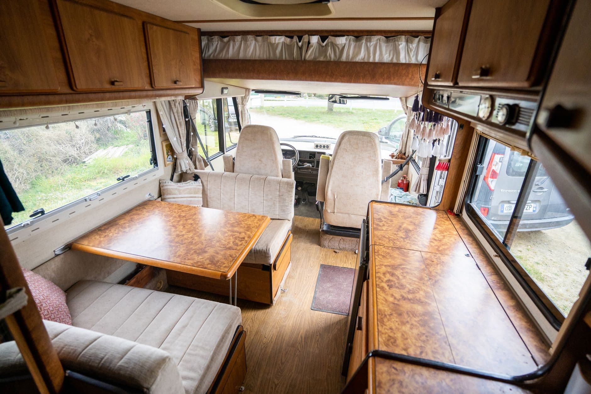 The interior of a classic camper van with wooden furniture